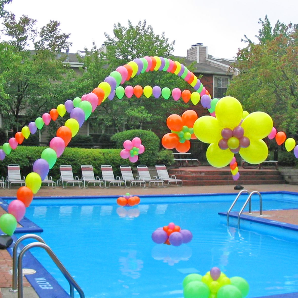 Pool-arch-by-airheads-balloon-art Pearl Arch and floaties over swimming pool for family picnic