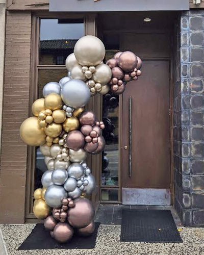 Organic-Garland-at-Door Metallic balloon garland installed at an outdoor building entrance